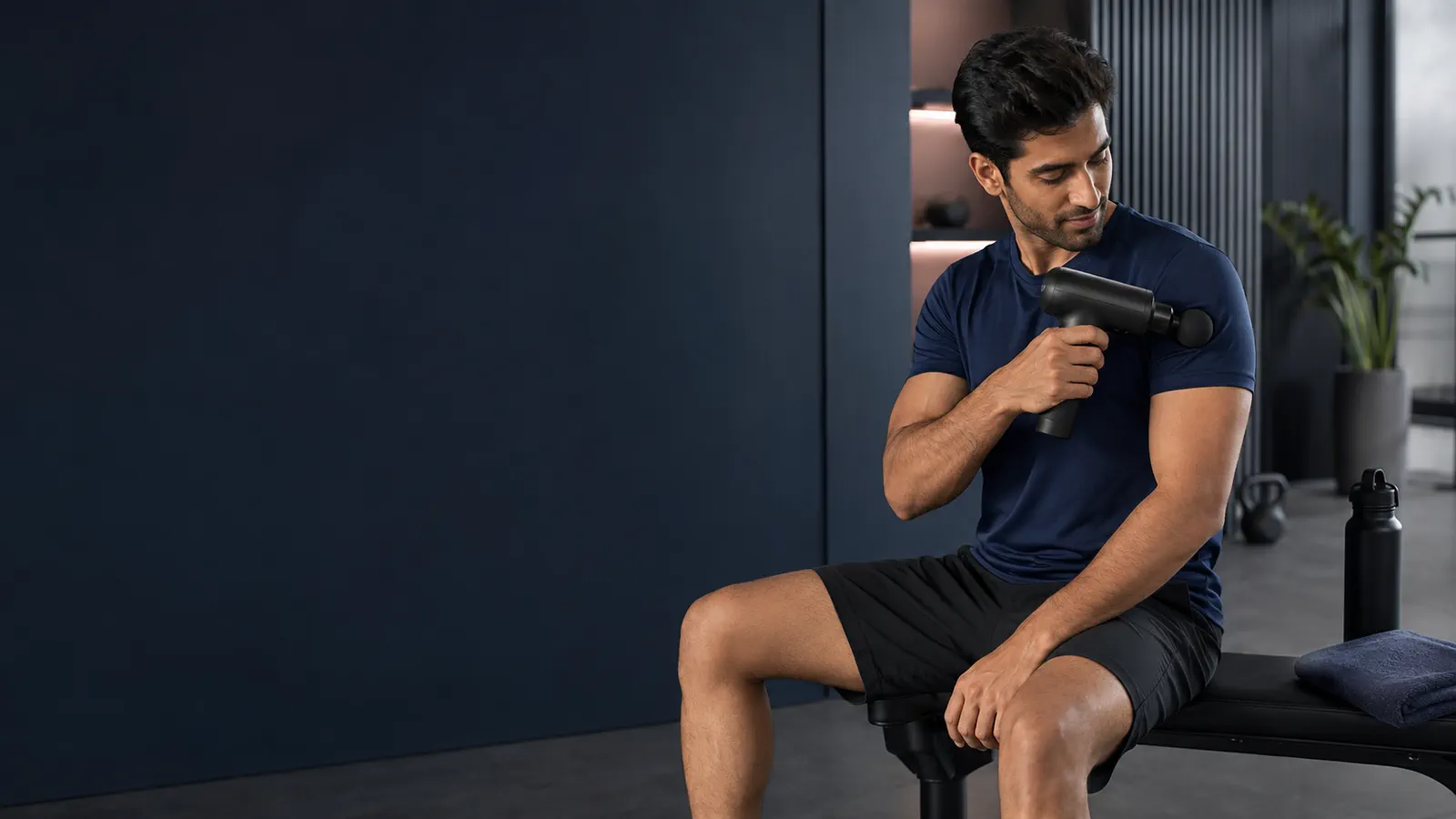 Man using a massage gun after a workout